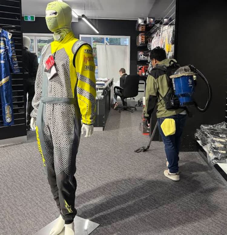 Leading FM cleaner vacuuming a retail store